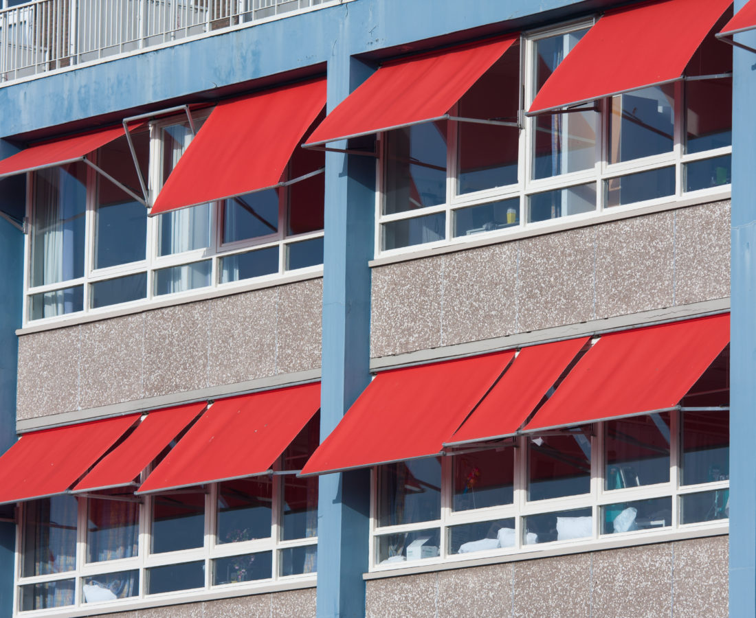 Facade of a modern building with red sunshades